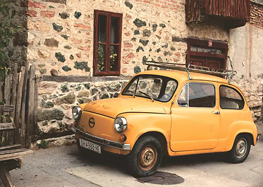 Vintage Yellow Car by Stone Building
