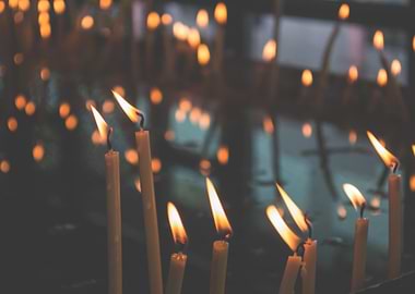 Candles burning in a dark space