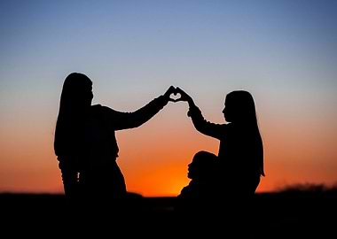 Silhouette of family making heart shape
