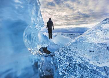 Man walking on icebergs, Iceland landscape