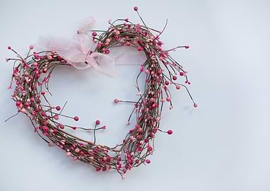 Heart-shaped berry wreath with pink ribbon