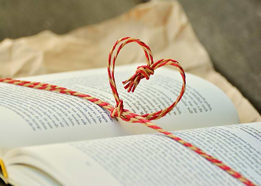 Heart-shaped string on open book