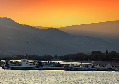 Sunset over the harbor with boats, Greek Island