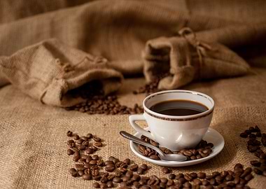 Coffee cup with beans and burlap