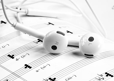 Earphones on Sheet Music in Black and White