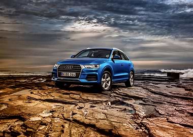 Blue Audi Q3 on Rocky Beach