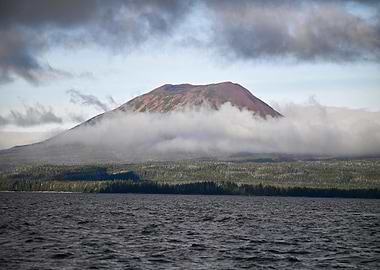 Mountain partially covered by clouds