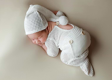 Sleeping Newborn in White Outfit