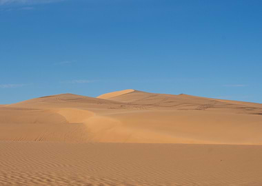 Sand Dunes Under a Blue Sky