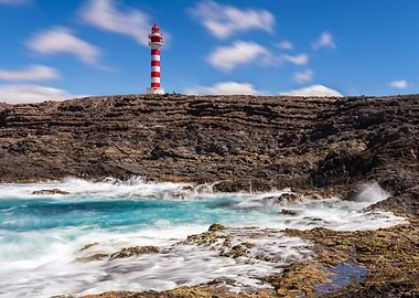 Red and White Lighthouse on Rocky Coast