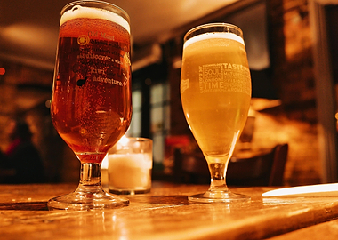 Two Beer Glasses on Wooden Table