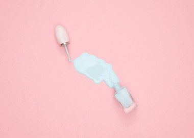 Spilled light blue nail polish on pink