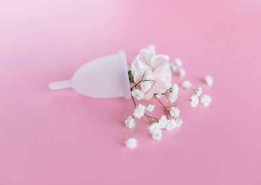 Menstrual cup with flowers on pink