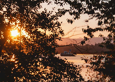Sunset over water with boat
