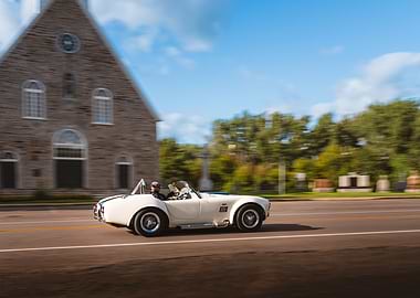 White Cobra car speeding on road
