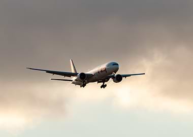 Boeing 777 landing in sunset