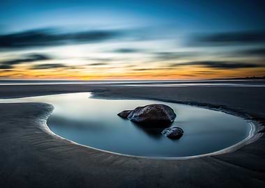 Tranquil Beach Sunset with Rocks