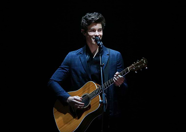 Shawn Mendes performing with guitar