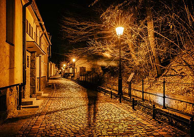 Night street with cobblestone and lamplight, Poland