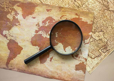 Magnifying Glass on Vintage World Map