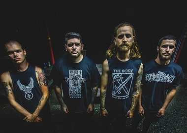 Four men in band t-shirts