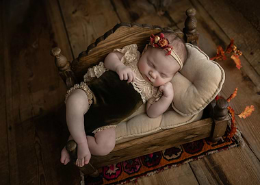 Sleeping Newborn in Wooden Bed
