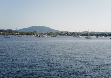 Lake with Sailboats and Mountain Backdrop