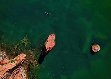 Aerial view of rowboat on green water