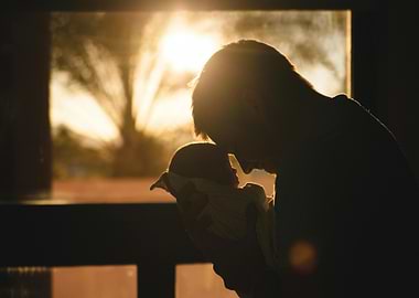 Father and Newborn Silhouette at Sunset