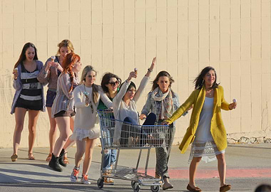 Girls having fun with shopping cart
