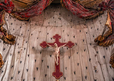 Crucifix on ornate wall with drapery