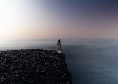 Calm Ocean View with Wooden Breakwater