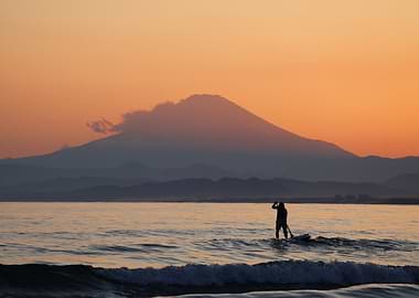 Mount Fuji at sunset with surfer
