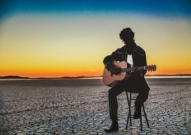 Unknown Guitarist at Sunset in Desert