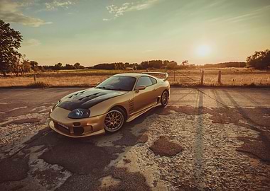 Gold Toyota Supra at Sunset