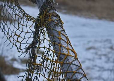 Weathered Net on Wooden Post