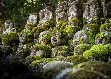 Moss-Covered Stone Statues in Japanese Garden