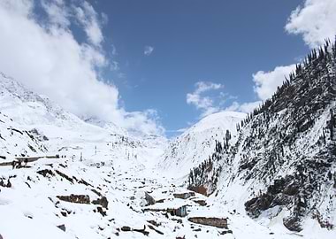 Snowy Mountain Valley with Small Buildings