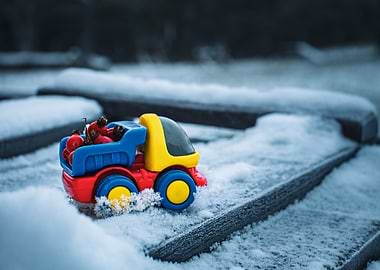 Toy truck in snow with berries