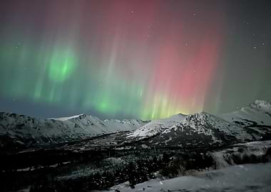Aurora Borealis over Snowy Mountains in Alaska