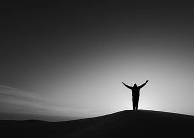 Silhouette of a person on a dune