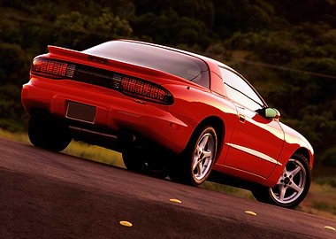 Red Pontiac Firebird on Road