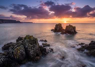 Coastal Sunset with Rocks and Waves