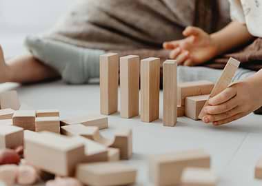 Child playing with wooden building blocks
