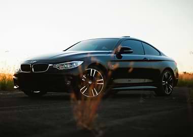 Sleek Black BMW Coupe at Sunset