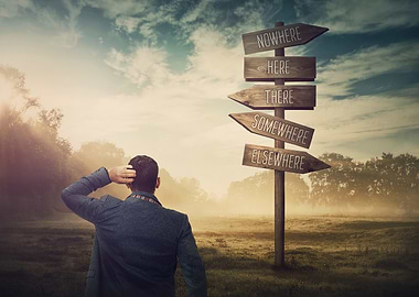 Man at Crossroads Signpost