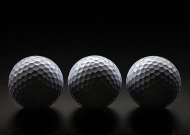 Three Golf Balls on Dark Background