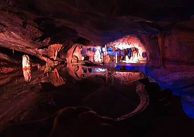 Illuminated Cave with Stalactites and Water