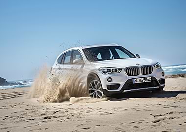 White BMW X1 on Sandy Beach
