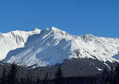 Snowy Mountain Peaks Under Blue Sky in Alaska